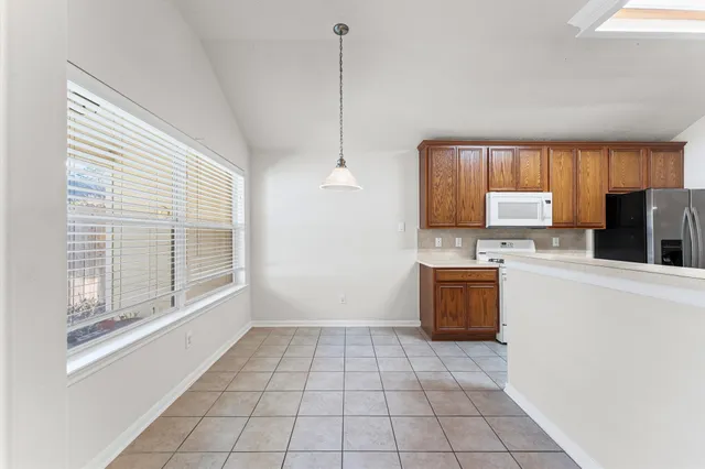 a kitchen with a sink stove top oven and cabinets