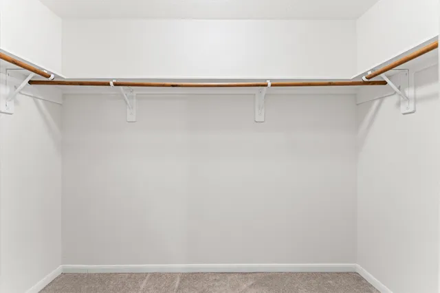 a view of city street with a building and trees in the background