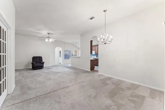a view of a livingroom with a ceiling fan and window