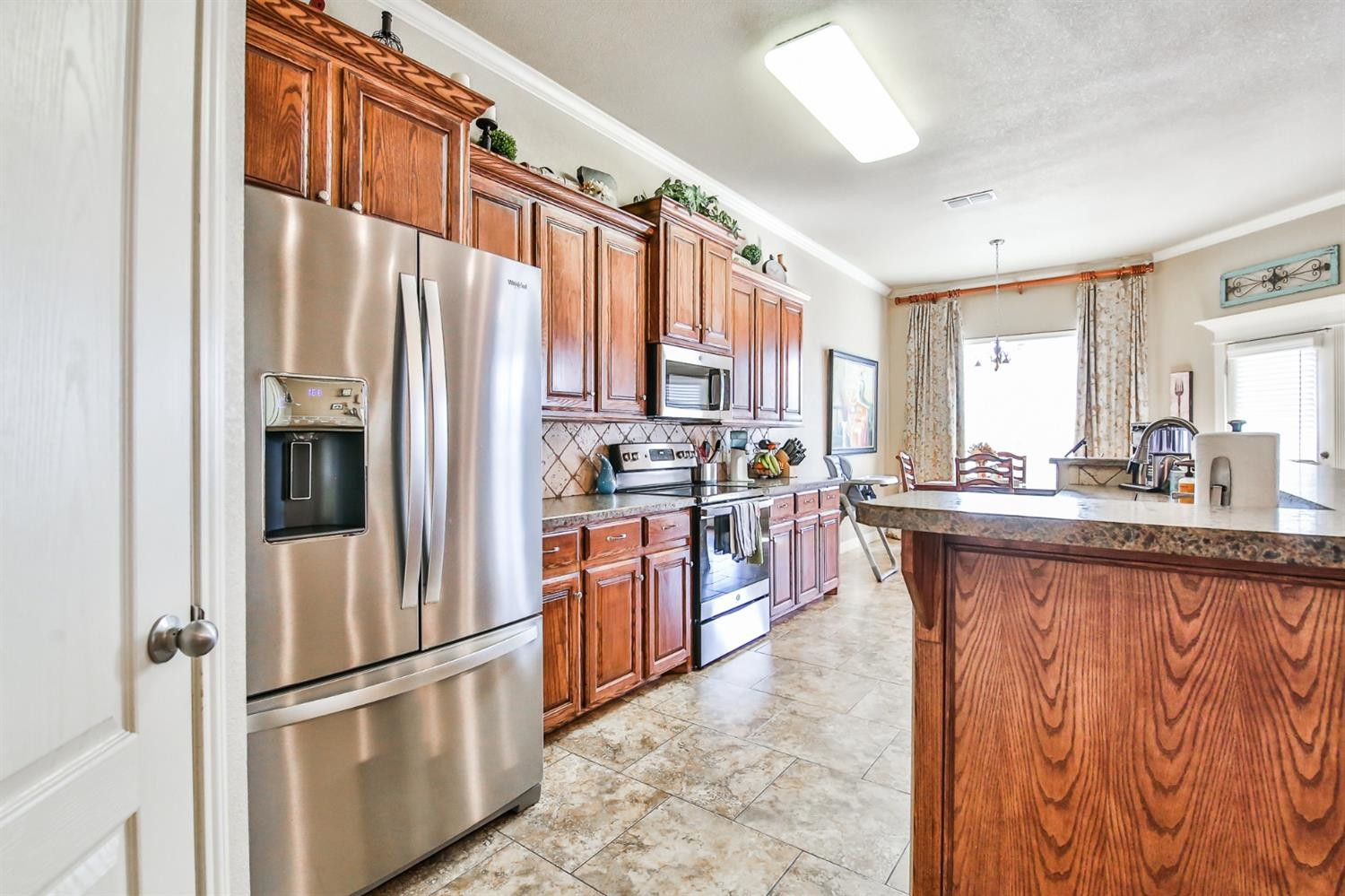 6205 101st Place Lubbock, TX 79424 - Photo 12 of 37 a kitchen with stainless steel appliances granite countertop a refrigerator and a sink
