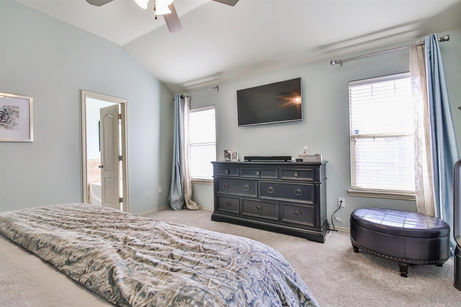6205 101st Place Lubbock, TX 79424 - Photo 19 of 37 a bedroom with a bed and a flat screen tv