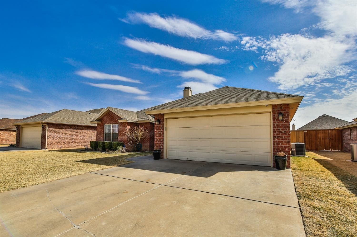 6205 101st Place Lubbock, TX 79424 - Photo 2 of 37 a front view of a house with a yard and garage
