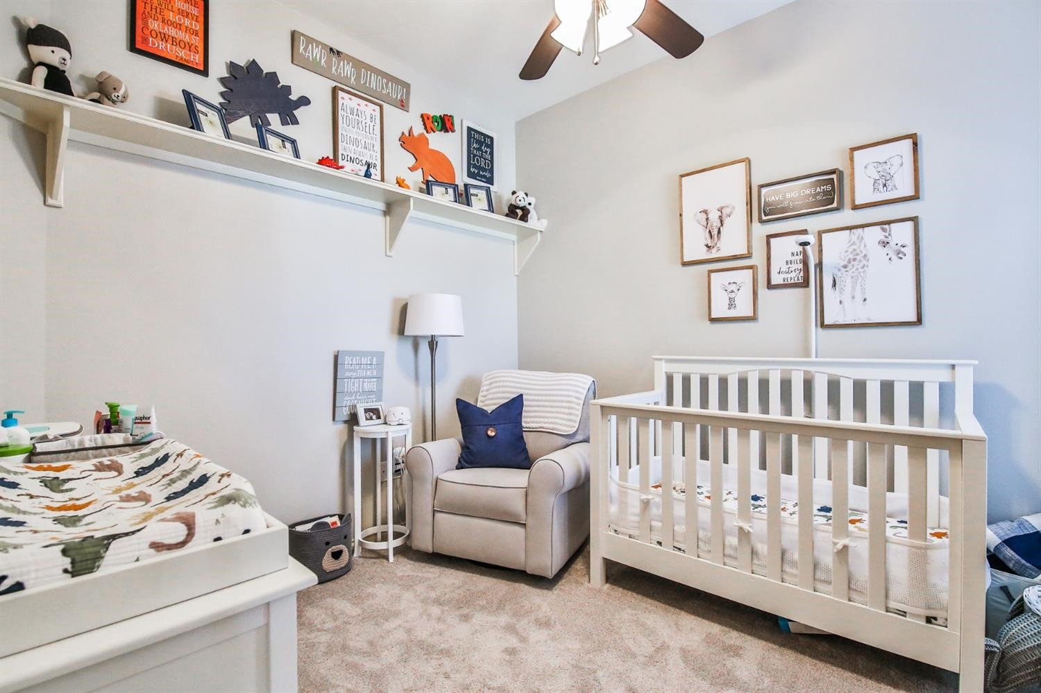 6205 101st Place Lubbock, TX 79424 - Photo 27 of 37 a bedroom with a baby bed a couch and a chandelier