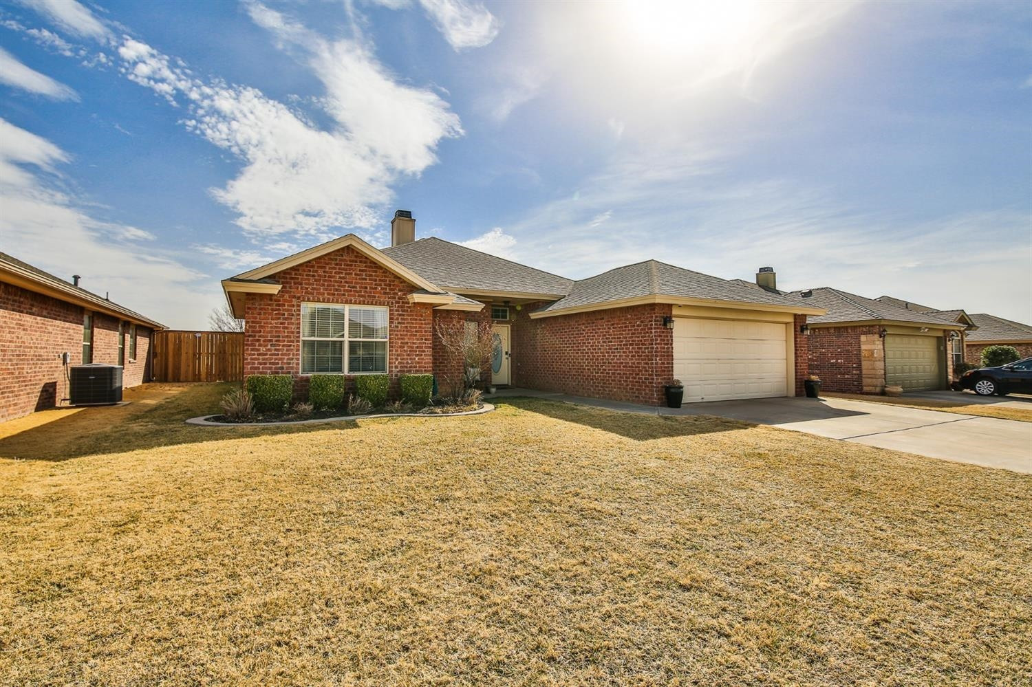 6205 101st Place Lubbock, TX 79424 - Photo 3 of 37 a front view of a house with a yard and garage