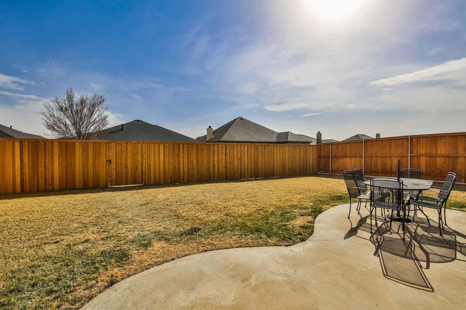 6205 101st Place Lubbock, TX 79424 - Photo 35 of 37 a view of a backyard with table and chairs with wooden fence