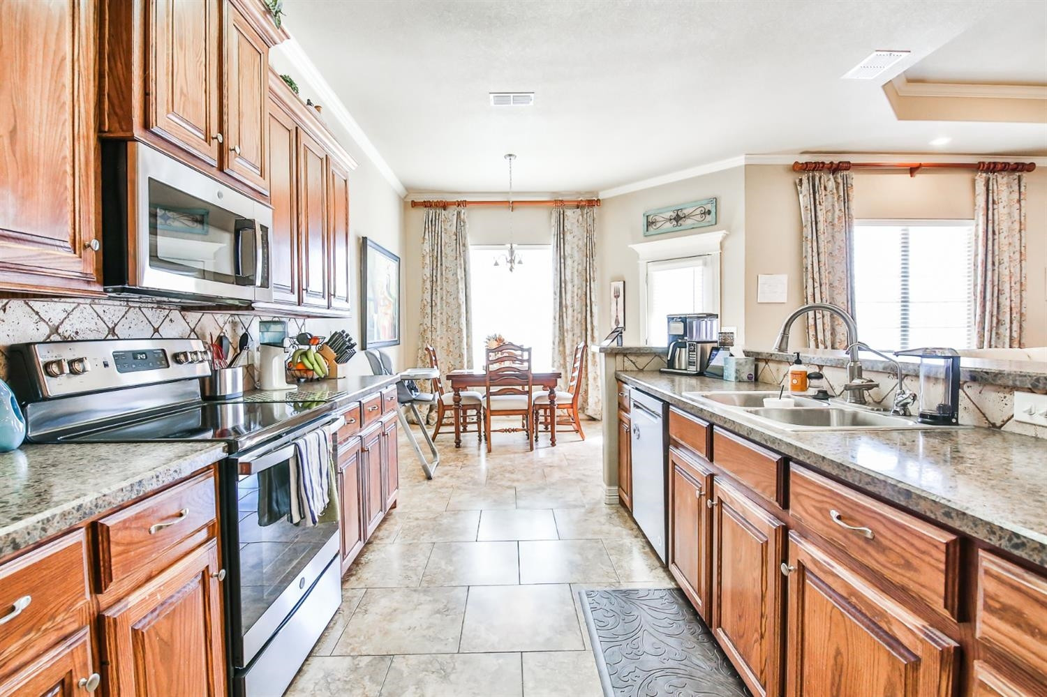 6205 101st Place Lubbock, TX 79424 - Photo 9 of 37 a kitchen with stainless steel appliances granite countertop a stove and cabinets