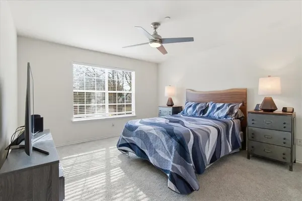 a spacious bedroom with a bed and a window