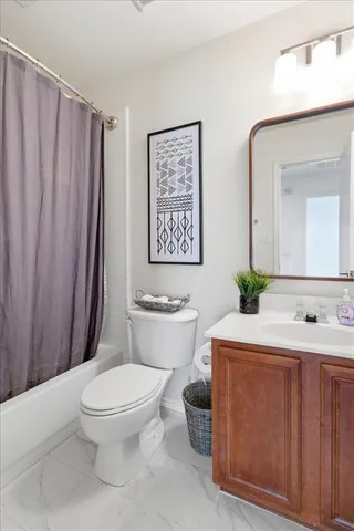 a bathroom with a toilet a sink and a mirror