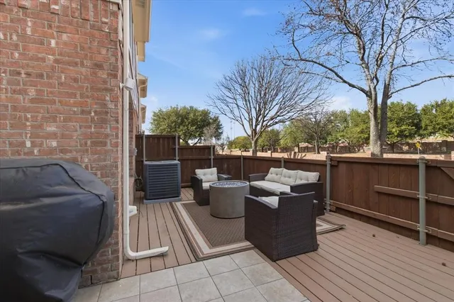 a view of a roof deck with couches and potted plants
