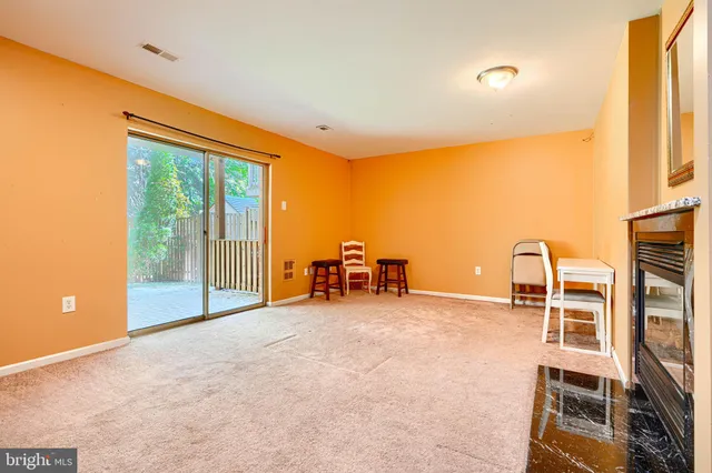 a view of a room with gym equipment and large windows