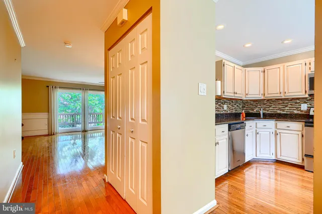 a view of a kitchen with wooden floor and a window