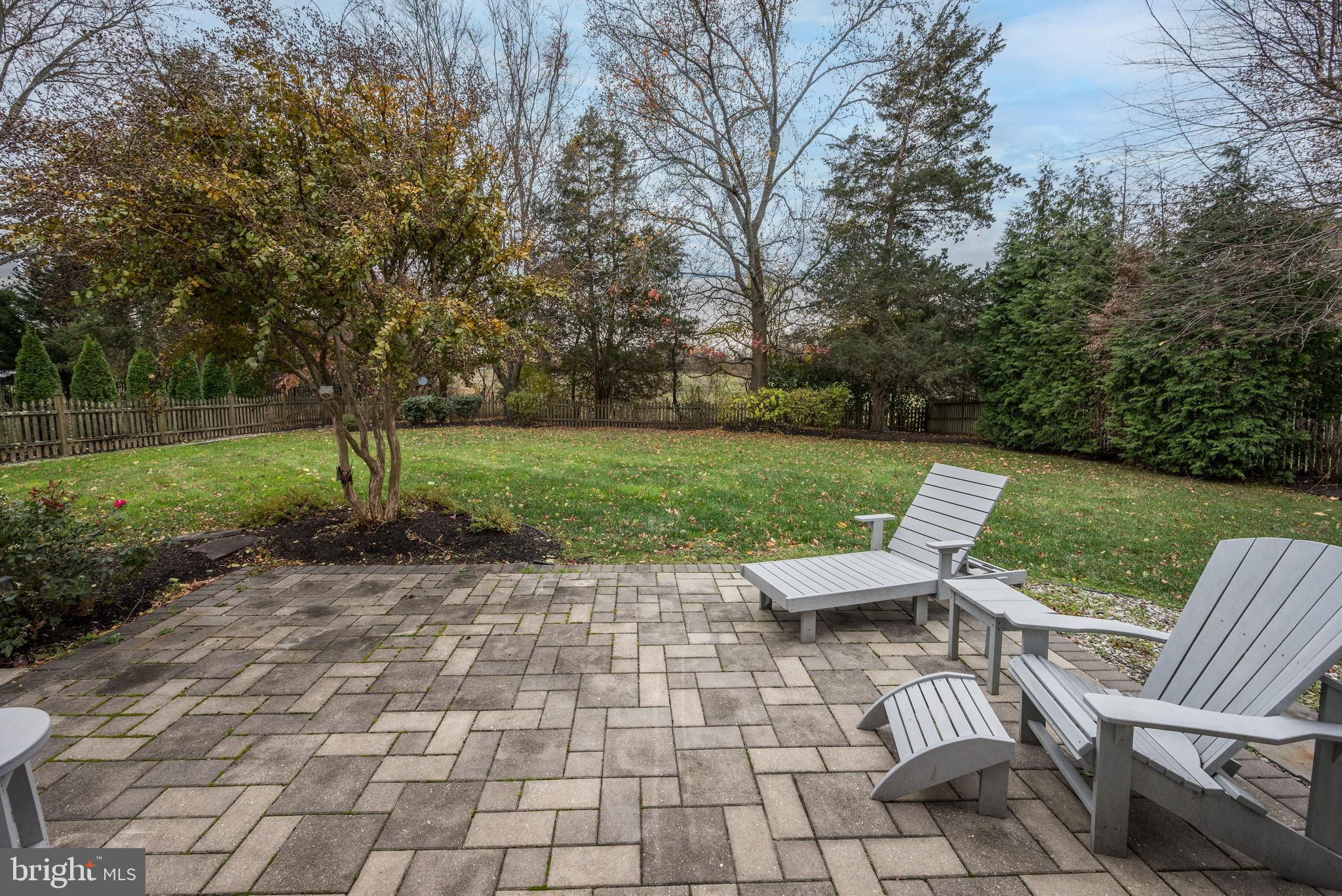 9 Swift Court Medford, NJ 08055 - Photo 44 of 54 a view of a patio with lawn chairs under an umbrella