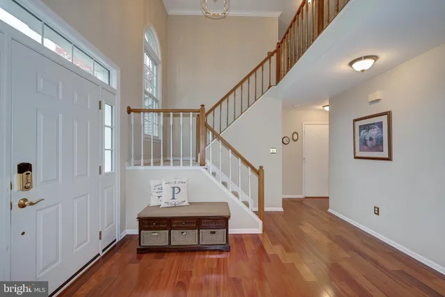 a view of entryway with wooden floor and stairs