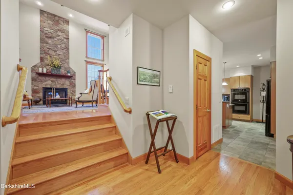 a kitchen with stainless steel appliances granite countertop a sink and a refrigerator
