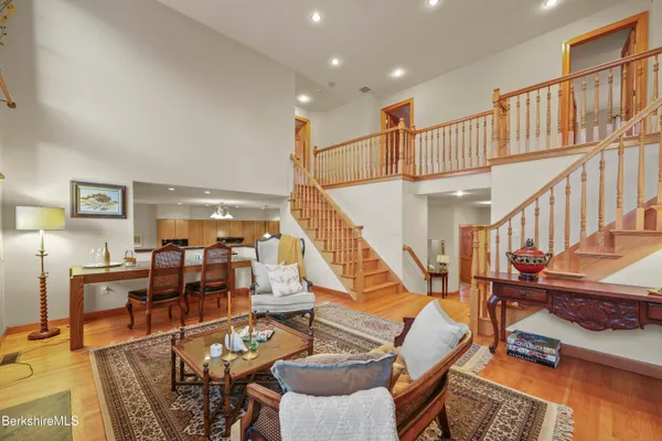 a kitchen with a stove a refrigerator a sink a dining table and chairs