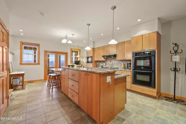 a bathroom with a granite countertop double vanity and a mirror