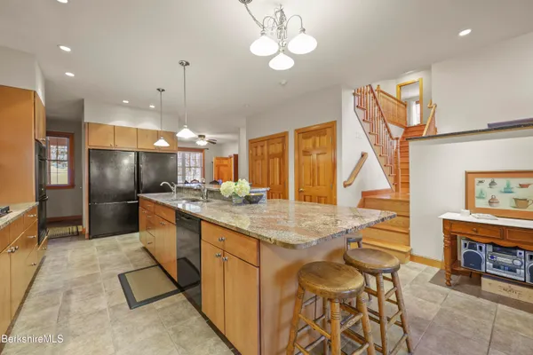 a spacious bedroom with a bed and a large window with outer view