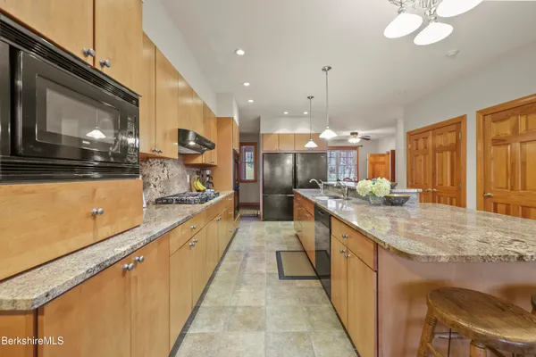 a spacious bedroom with a bed and a chandelier