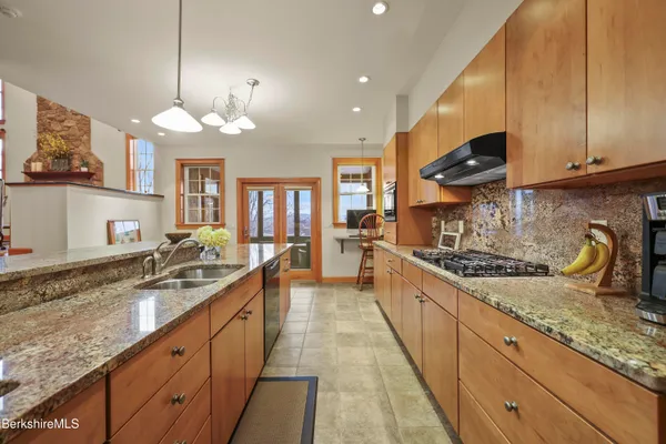 a bedroom with a bed chandelier and a window