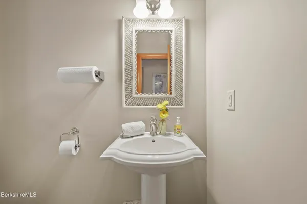 a bathroom with a double vanity sink toilet and shower