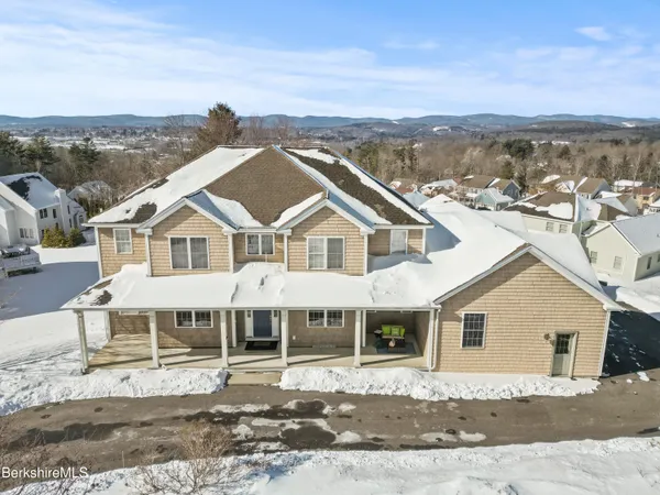 a view of a white house with a yard