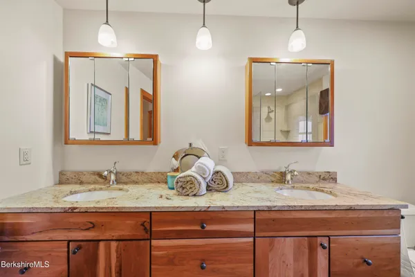 a bedroom with furniture a rug and wooden floor