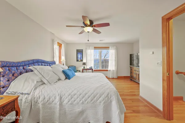 a large bathroom with a large mirror vanity and a shower