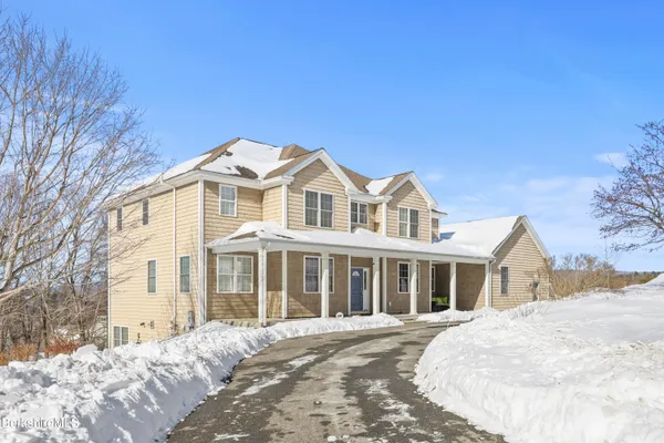 a living room with furniture a rug and a window