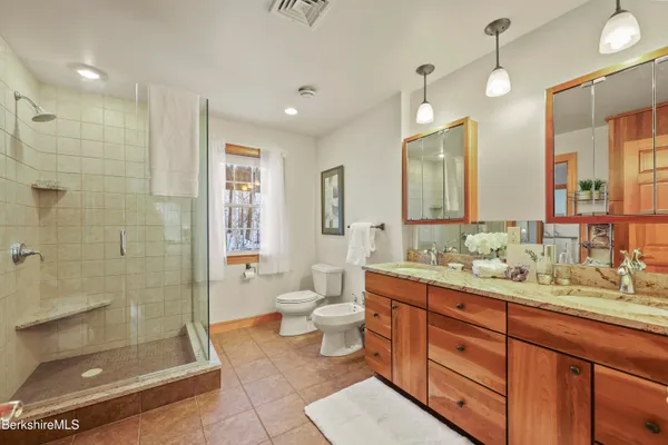 a front view of a house with a road