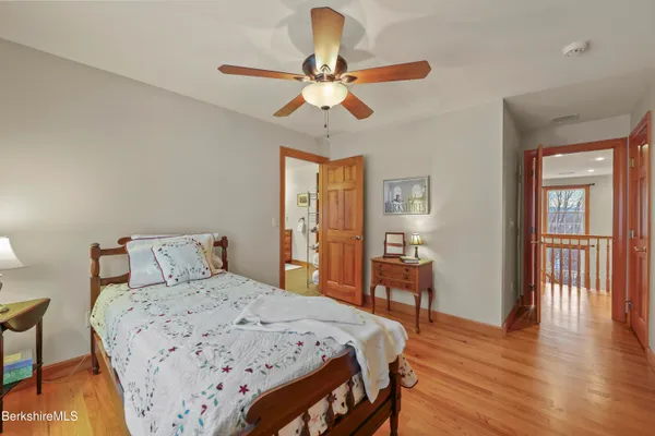 a view of a white house with a big yard and a wooden deck