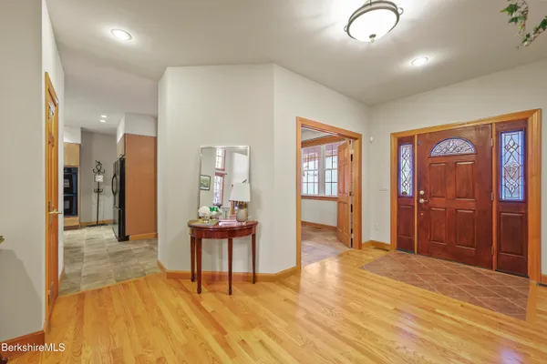 a view of a livingroom with furniture wooden floor and windows