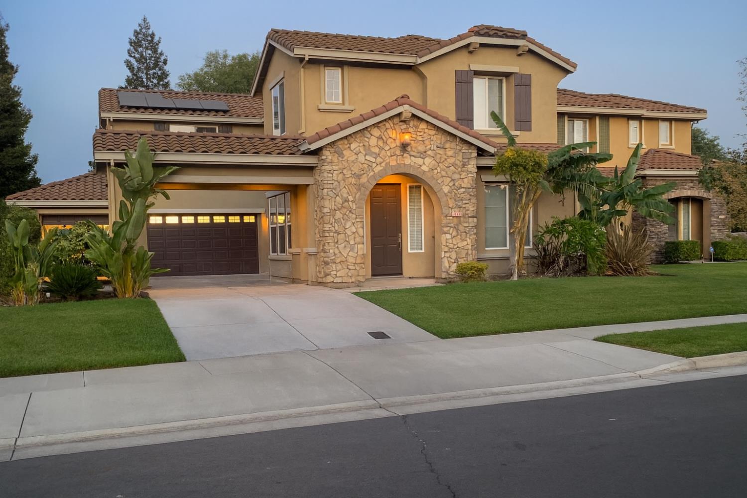 10148 Tony Court Stockton, CA 95209 - Photo 1 of 12 a front view of a house with a yard and garage