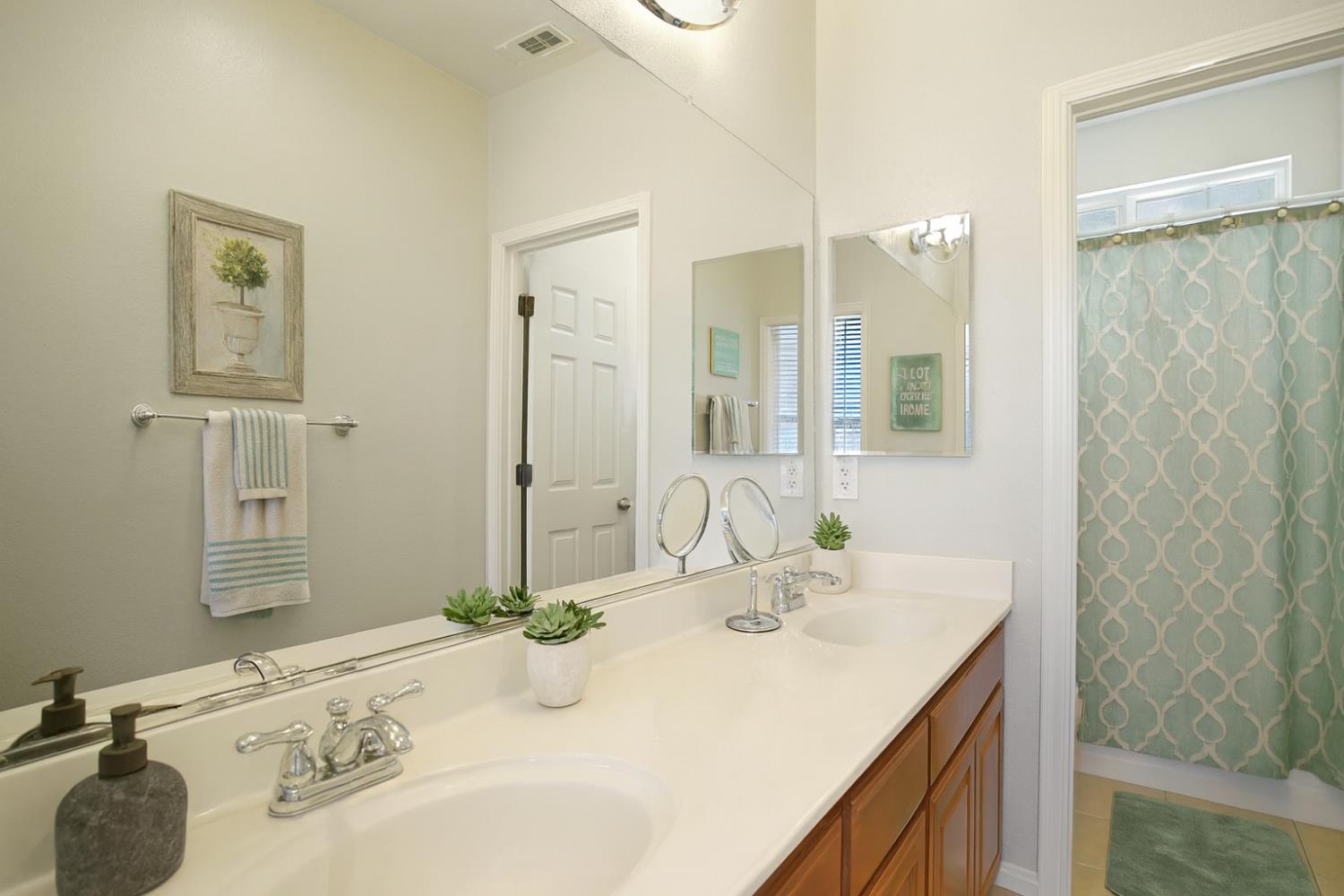 10148 Tony Court Stockton, CA 95209 - Photo 7 of 12 a bathroom with a sink and a mirror