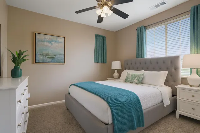 a bedroom with a large bed and a chandelier