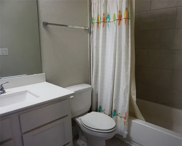 a white toilet sitting next to a bathroom sink