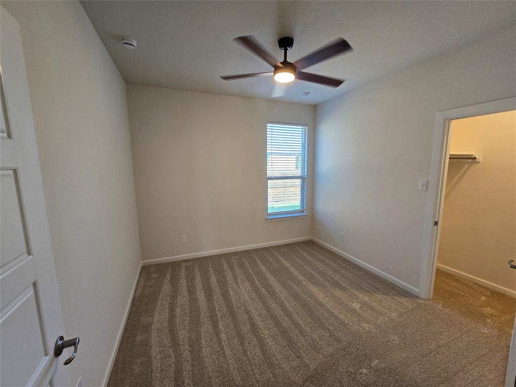 508 Williams Way Van Alstyne, TX 75495 - Photo 16 of 26 an empty room with windows and fan