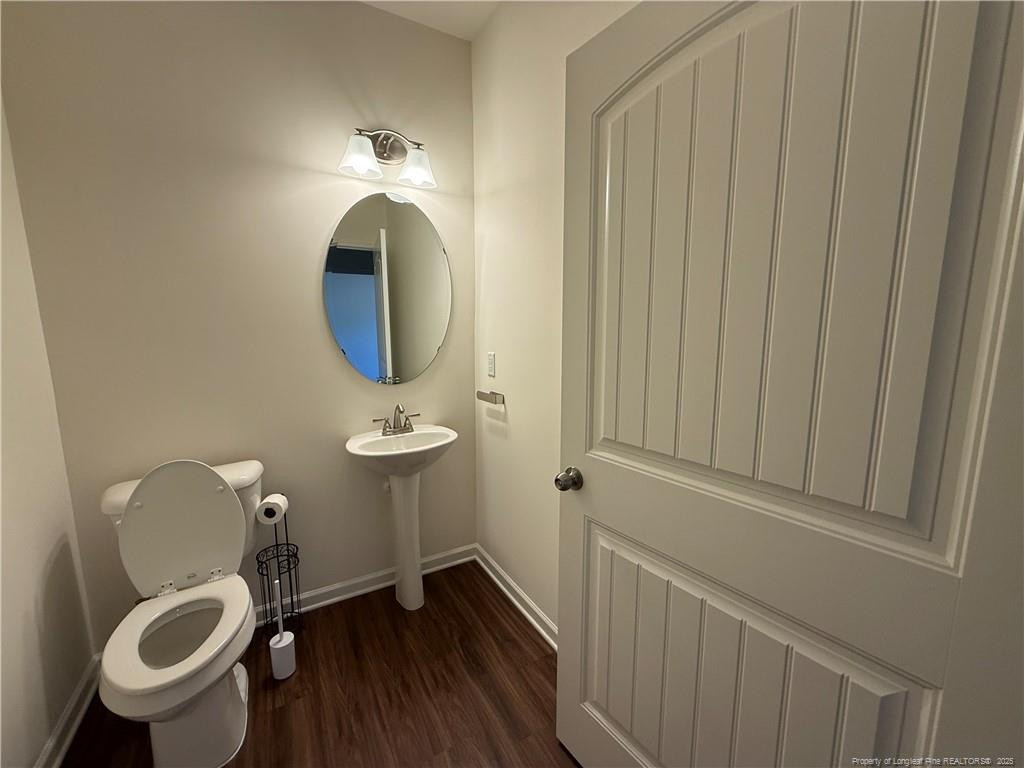 240 Planters Lane Coats, NC 27521 - Photo 11 of 18 a bathroom with a toilet a sink and mirror