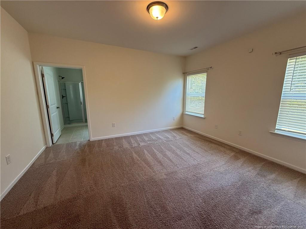 240 Planters Lane Coats, NC 27521 - Photo 12 of 18 an empty room with windows and closet