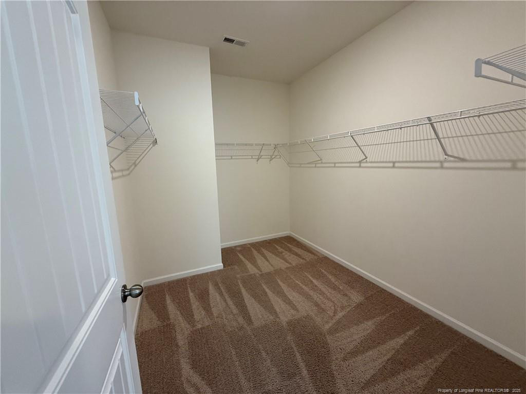 240 Planters Lane Coats, NC 27521 - Photo 14 of 18 a view of a room with racks on the wall