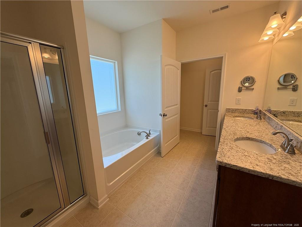 240 Planters Lane Coats, NC 27521 - Photo 15 of 18 a bathroom with a granite countertop sink and a mirror