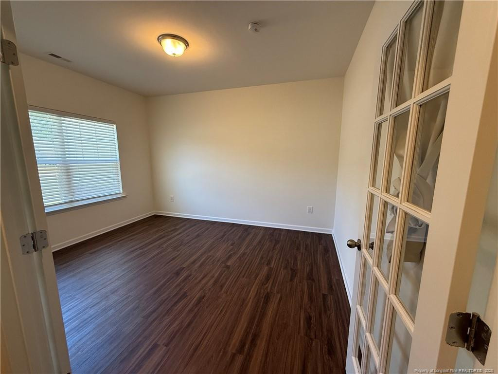 240 Planters Lane Coats, NC 27521 - Photo 2 of 18 an empty room with wooden floor and windows