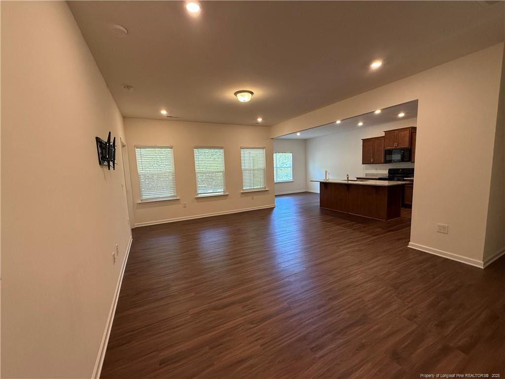 240 Planters Lane Coats, NC 27521 - Photo 3 of 18 an empty room with wooden floor and windows