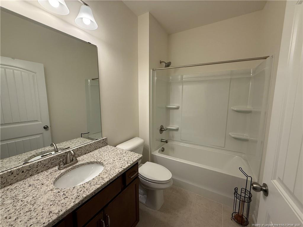240 Planters Lane Coats, NC 27521 - Photo 7 of 18 a bathroom with a granite countertop sink toilet mirror and shower
