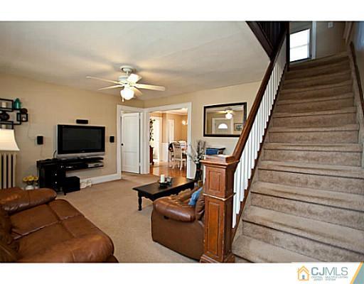 1982 Oak Tree Road Edison, NJ 08820 - Photo 15 of 25 a living room with furniture and a flat screen tv