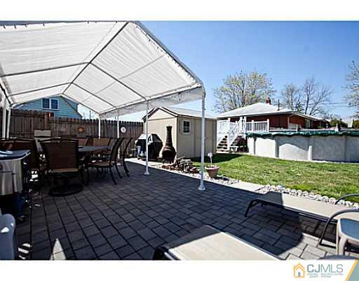 1982 Oak Tree Road Edison, NJ 08820 - Photo 18 of 25 a view of a patio with table and chairs under an umbrella