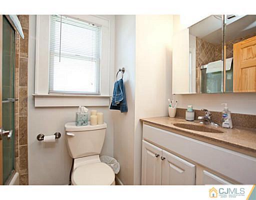 1982 Oak Tree Road Edison, NJ 08820 - Photo 9 of 25 a bathroom with a toilet sink and mirror