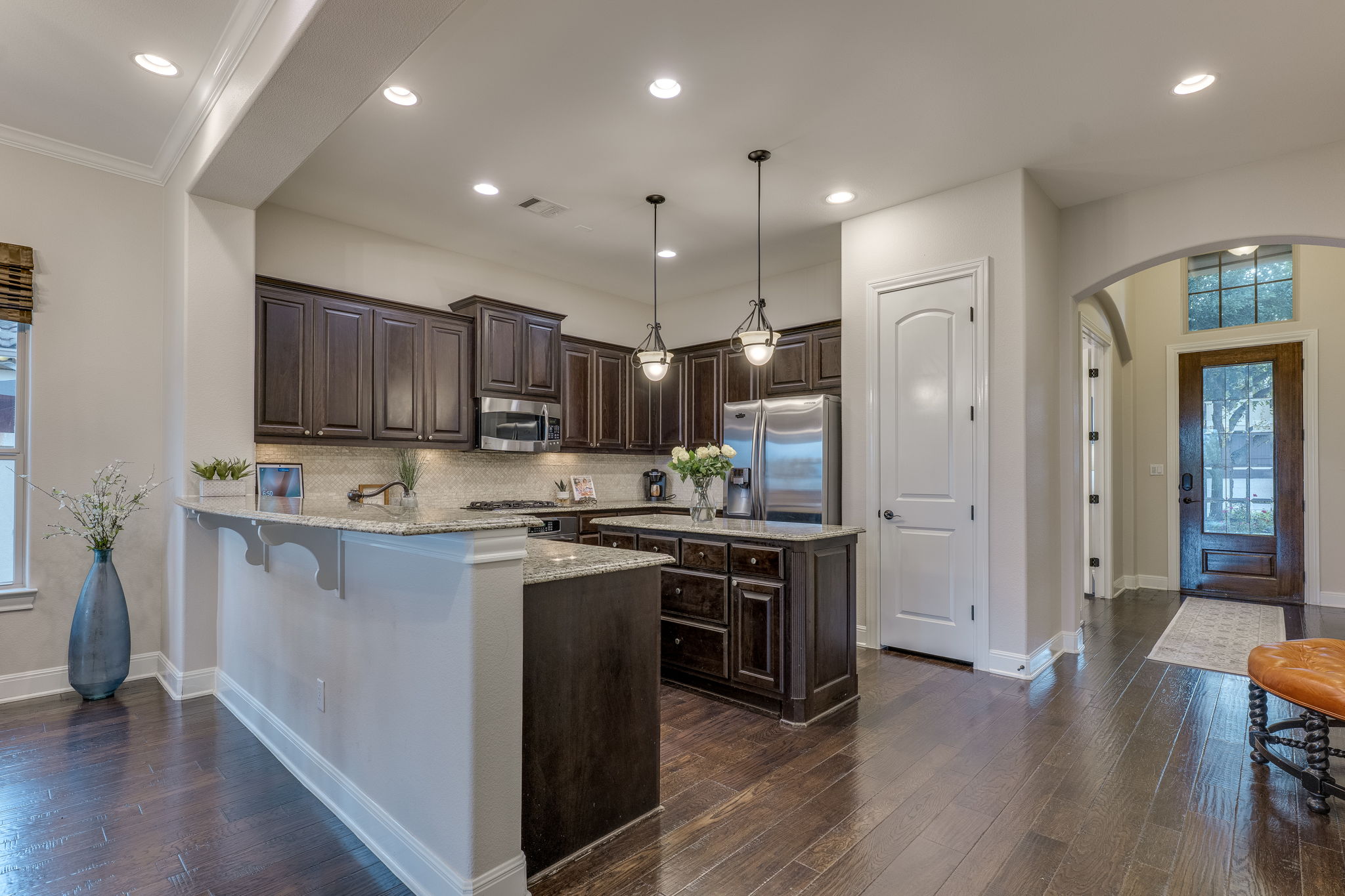 11601 Shadestone Terrace Austin, TX 78732 - Photo 15 of 40 a kitchen with kitchen island granite countertop wooden floors and stainless steel appliances