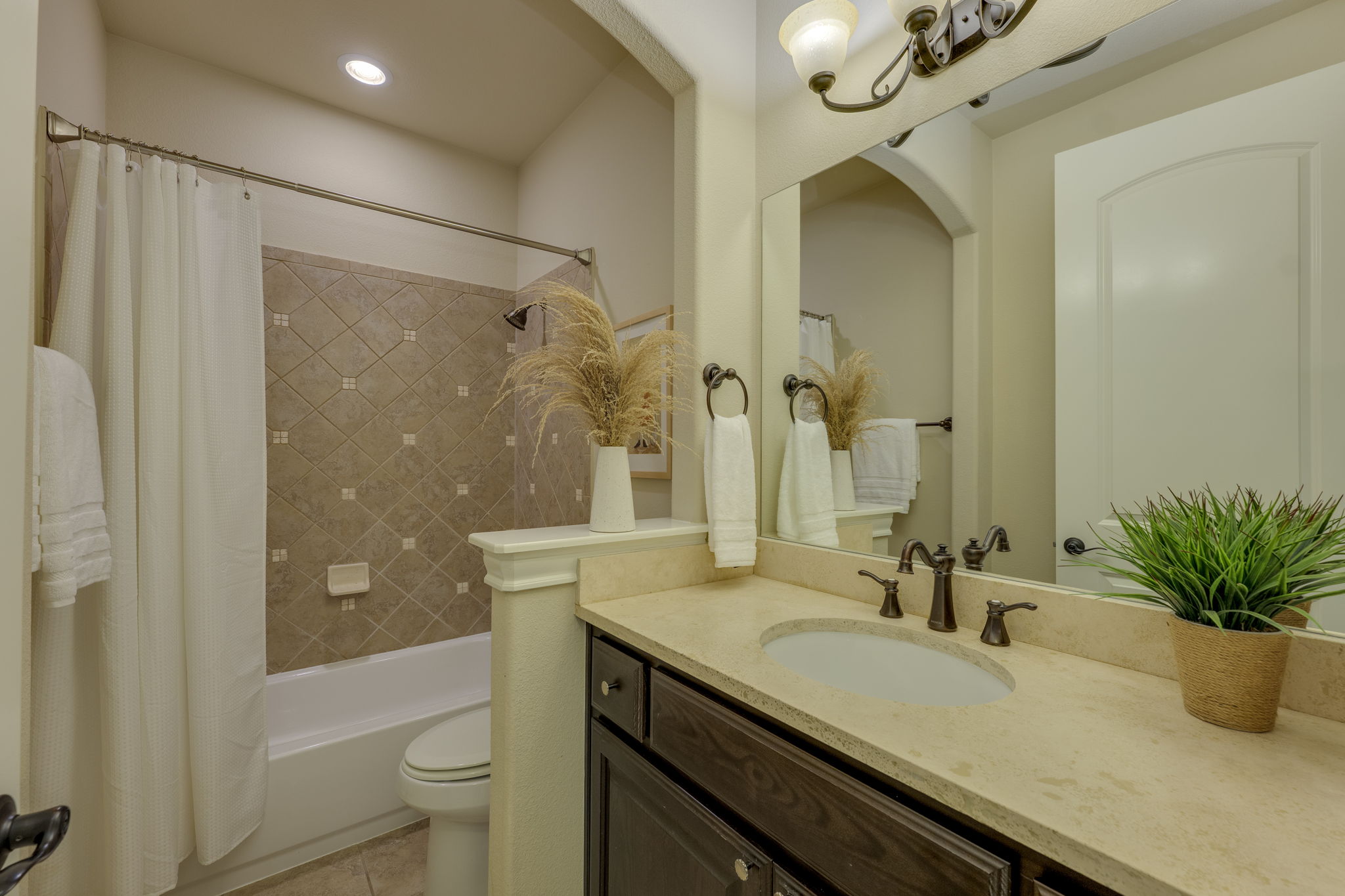 11601 Shadestone Terrace Austin, TX 78732 - Photo 36 of 40 a bathroom with a granite countertop sink a toilet and shower