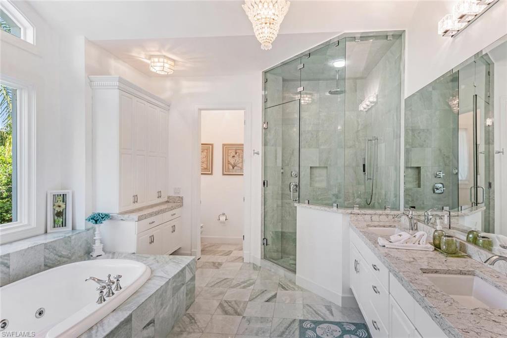 2540 Half Moon Walk Naples, FL 34102 - Photo 26 of 44 a bathroom with a granite countertop tub sink a shower and a mirror