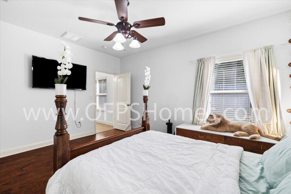 4632 Hermosa Road Crestview, FL 32539 - Photo 13 of 35 a bedroom with a bed a flat screen tv and a large window